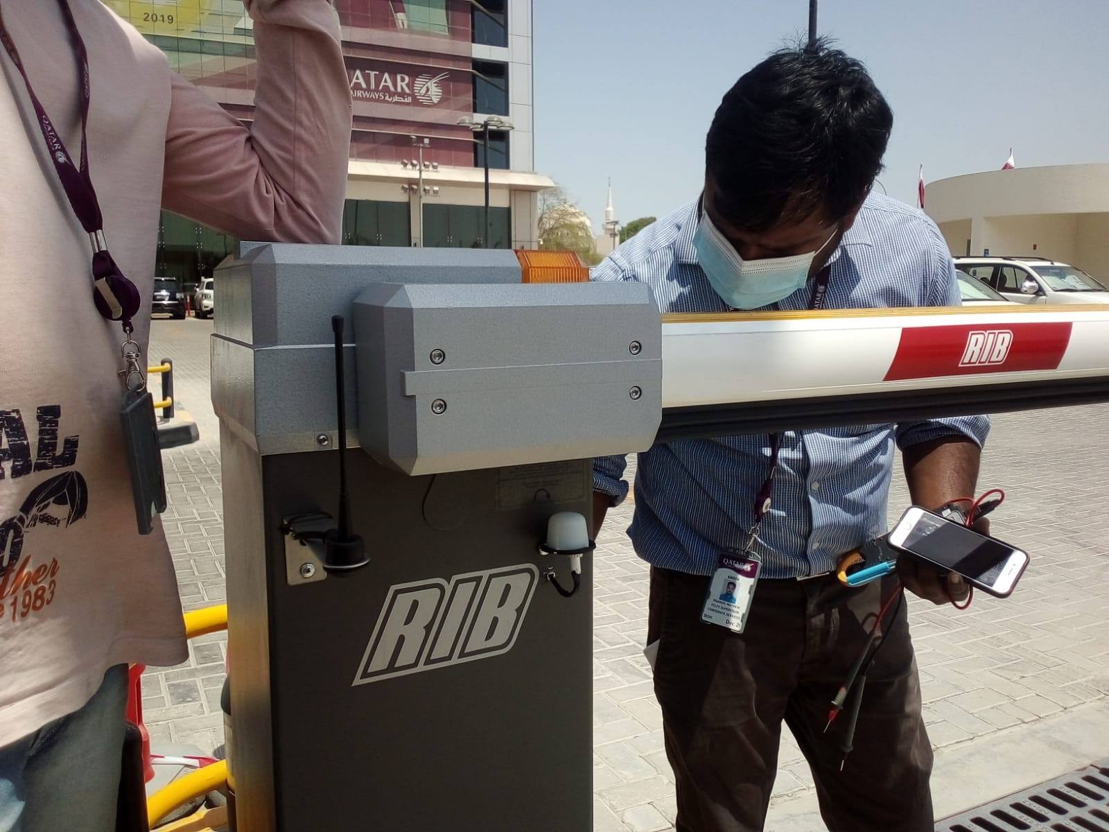 Al-Najah technician installing a RIB automatic vehicle barrier