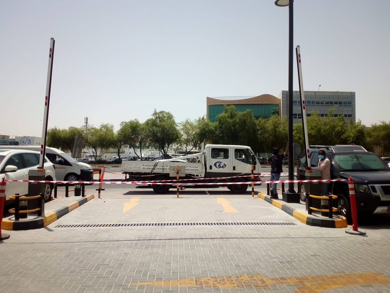 Vehicle entry and exit barriers at a parking entrance